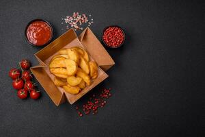 Delicious crispy fried potato wedges with salt, spices and herbs photo