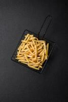 Fresh delicious crispy French fries with salt and spices photo