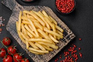 Fresh delicious crispy French fries with salt and spices photo