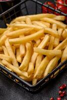 Fresh delicious crispy French fries with salt and spices photo