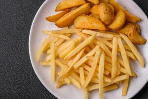 Fresh delicious crispy French fries with salt and spices photo