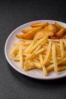 Fresh delicious crispy French fries with salt and spices photo