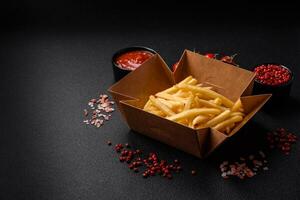 Fresh delicious crispy French fries with salt and spices photo