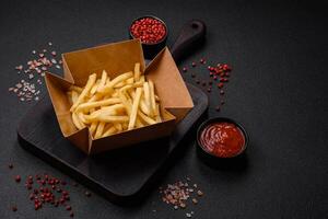 Fresh delicious crispy French fries with salt and spices photo