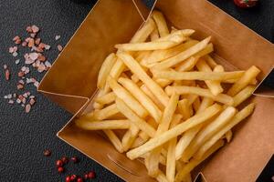 Fresh delicious crispy French fries with salt and spices photo