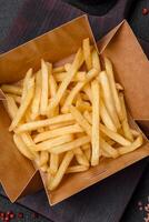 Fresh delicious crispy French fries with salt and spices photo