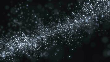 Abstract elegant particles on a dark background. Flying luminous points of particles swirl like magical waves. seamless loop video