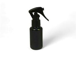 Black spray bottle on white background photo