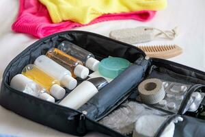 Travel cosmetics kit on bed , top view photo