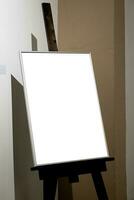 Blank picture frames on grey wall with glowing lamp, mock up photo