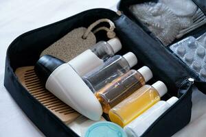 Travel cosmetics kit on bed , top view photo