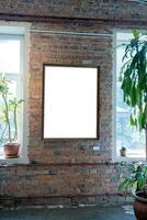 Blank picture frames on brick wall with glowing lamp, mock up photo