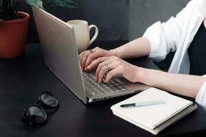 Close-Up of Woman's Hands Typing on Laptop. Online Learning, Internet Marketing, Work from Home, Freelance, Office Workplace Concept photo