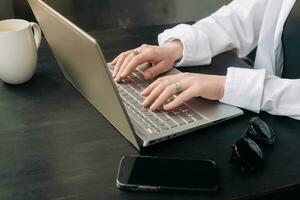 Professional Businesswoman Analyzing Strategy in Office. Laptop and Workroom Scene. Business woman professional work in the office, analyzing business strategy, woman use a laptop in the workroom. photo