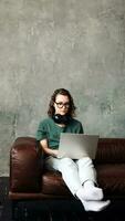 Digital Freelance Lifestyle. Young Woman Working or Studying from Home on Laptop - Emphasizing Remote Learning, Business, and Modern Living Concepts photo