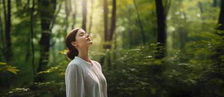 Harmony, Close to Nature Concepts, a Young Female Take Deep Breathing Fresh Air in the Green Forest Woods. Engaging Body and Mind with Nature, Eyes Closed. Concept of Calm, Meditation. photo
