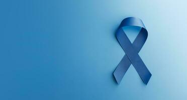Prostate Cancer Awareness Campaign Concept. Men Healthcare. Close up of a Blue Ribbon Lying on blue background, Top View photo