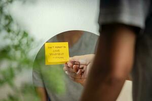 Self Love Concept. Person Reading Note on the Mirror. Mental Health Remind and Practice to Start the Day with a Optimistic Mind photo