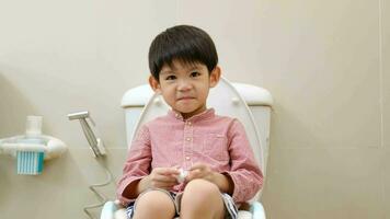 Asian boy Sitting on the toilet bowl video