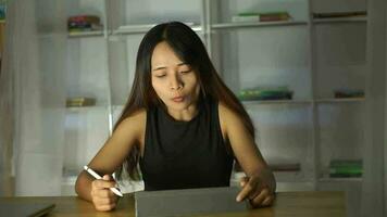 Woman working at home using a computer to communicate video