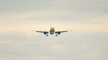 Jet plane approaching landing. Aircraft descending. Slow motion, airliner flying, front view video