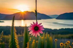 a pink flower is hanging from a vine in front of a lake. AI-Generated photo