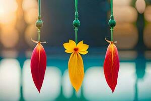 three colorful leaves hanging from a string. AI-Generated photo