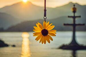 sunflower hanging from a rope in front of a lake. AI-Generated photo