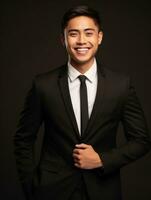Smiling young man of Asian descent dressed in suit on gray background AI Generative photo