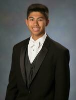 Smiling young man of Asian descent dressed in suit on gray background AI Generative photo