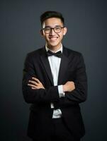 Smiling young man of Asian descent dressed in suit on gray background AI Generative photo