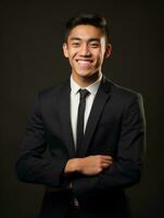 Smiling young man of Asian descent dressed in suit on gray background AI Generative photo