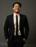 Smiling young man of Asian descent dressed in suit on gray background AI Generative photo