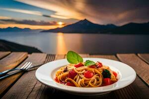 un plato de pasta con Tomates y brócoli en un mesa en frente de un lago. generado por ai foto