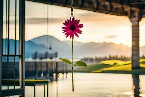 a pink flower hanging from a string near a lake. AI-Generated photo