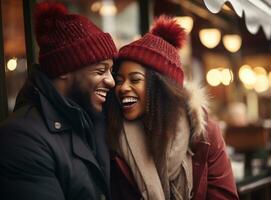 a couple holding hands while laughing and sharing a hat or beanie in winter city photo