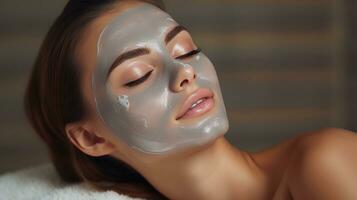 a woman getting a facial mask treatment at a beauty salon photo