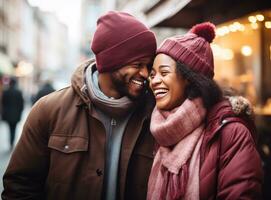 a couple holding hands while laughing and sharing a hat or beanie in winter city photo