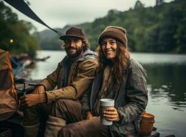 woman and man sitting and drinking coffee on the terrace by the river photo