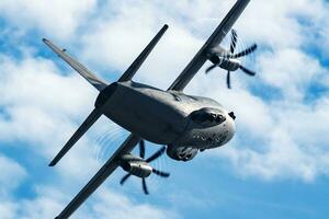 Untitled military transport plane at air base. Airport and airfield. Air force and army flight operation. Aviation and aircraft. Air lift. Military industry. Fly and flying. photo