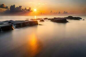 sunset over the ocean with rocks and water. AI-Generated photo