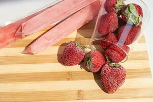 Ice cream in a bag with strawberries, sweet frozen homemade. Brazilian Dindin, chup-chup photo