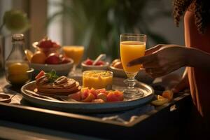 A person holding a tray of breakfast items, featuring a prominently placed glass of orange juice, showcasing its role as a vital part of a well-balanced meal. Generative Ai photo