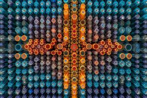 A composition of multiple vials filled with colorful vaccines, arranged in a symmetrical pattern, highlighting the efficiency and scale of production. Generative AI photo