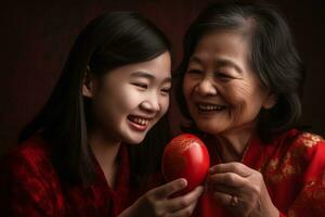 A mother and daughter laughing as they share a decorative red egg, a symbol of prosperity. Convey the closeness and joy of multi-generational families coming together. AI generative. photo