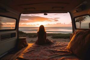 Van on the beach in Hawaii. A young woman sitting inside of it watching the sunset peacefully. Generative Ai photo