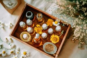 An overhead view of a wooden tray with chamomile flowers, essential oil, and dried petals, representing aromatherapy, natural skincare, and wellness concepts. Generative Ai photo