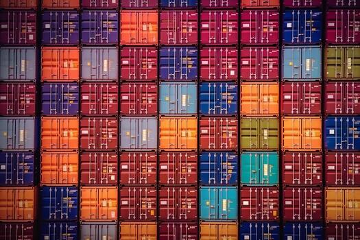 Rows of cargo shipping containers filmed by long focus camera. Multi-colored cargo shipment containers of different delivery cargo transportation companies. Generative AI photo