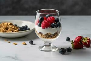 A light, refreshing breakfast of Greek yogurt, topped with a variety of fresh berries, honey, and granola, served in a glass parfait dish on a minimalist, marble tabletop. Generative AI. photo