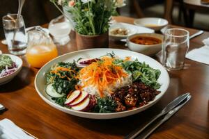 A meal consisting of veggie bibimbap, fresh salad dressed with edible flowers, bean chili and a kombucha tea. Minimally processed and naturally fermented food. Generative AI photo